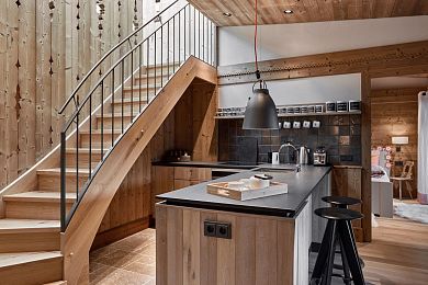 Fully equipped designer kitchen with stairs to a gallery bed